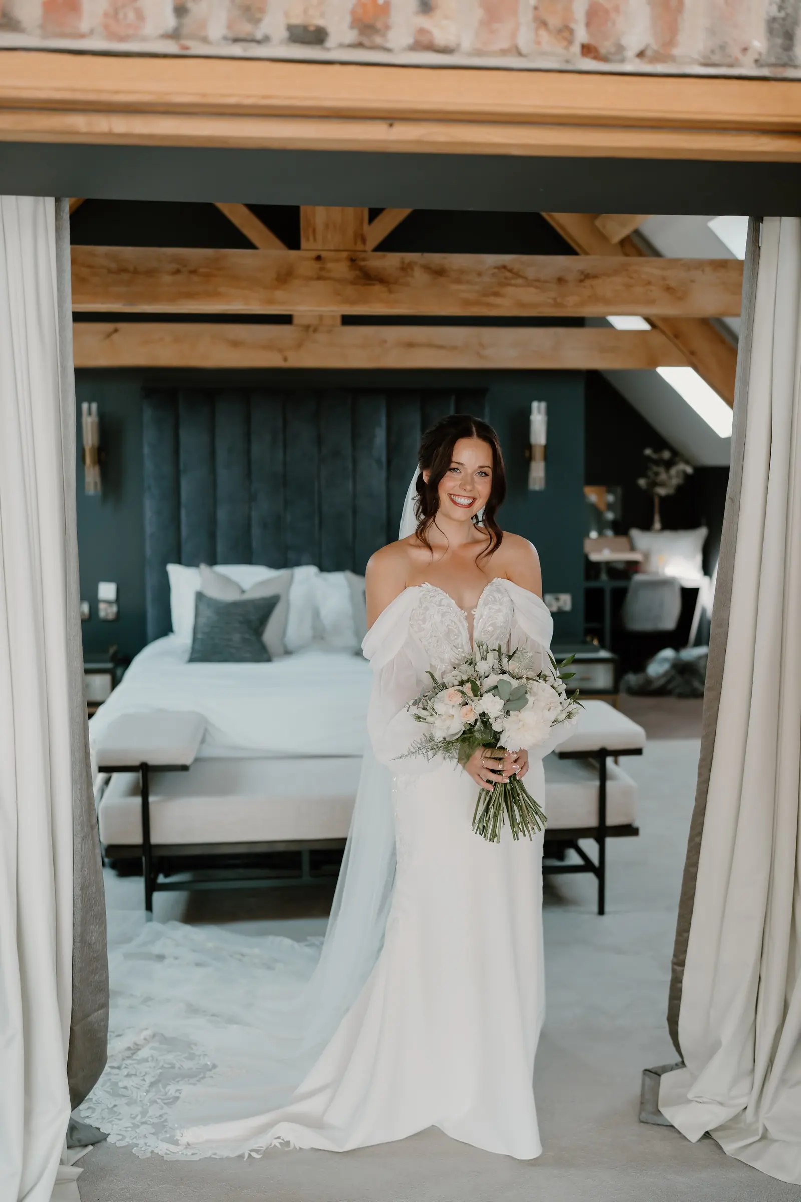 A bride in one of the bedrooms, beside a dark panelled wall