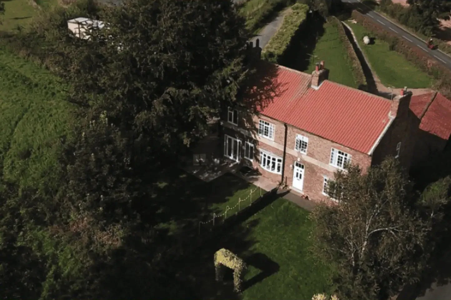 Bridge View cottage from above, with its garden running down to the river