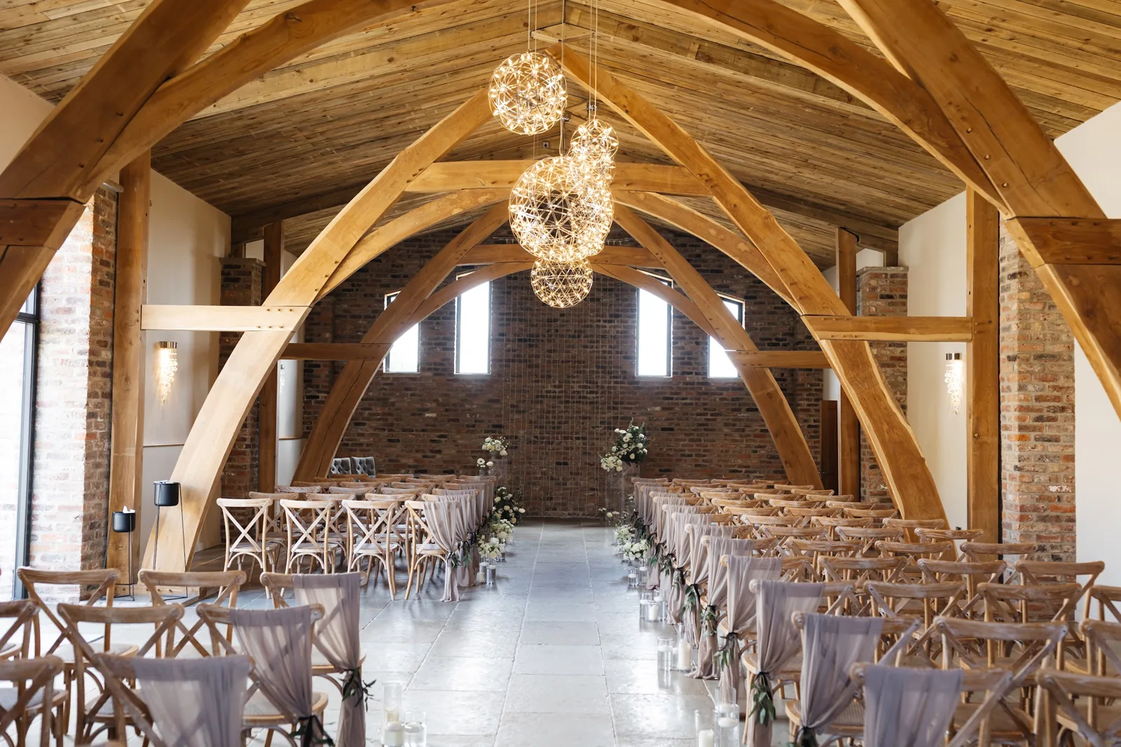 The Ceremony Hall set for a ceremony beneath its oak arches and globe pendants