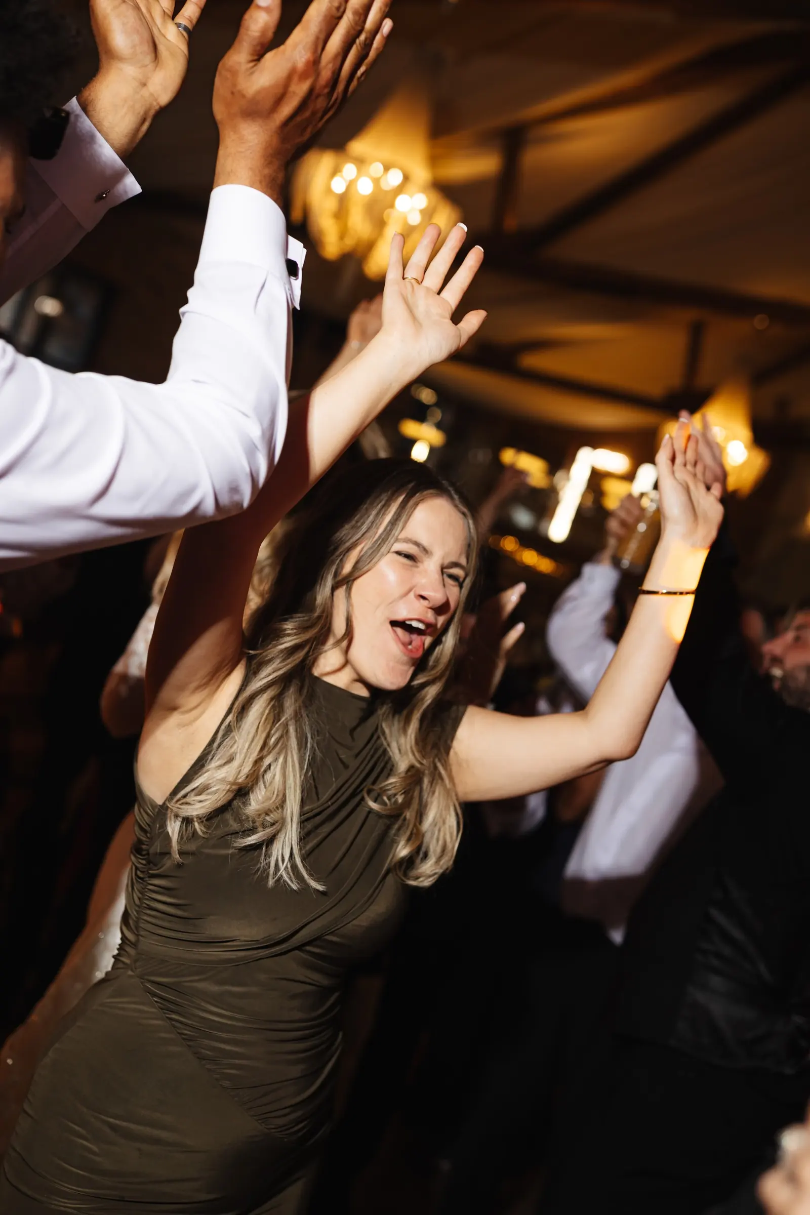A guest dancing with her hands in the air