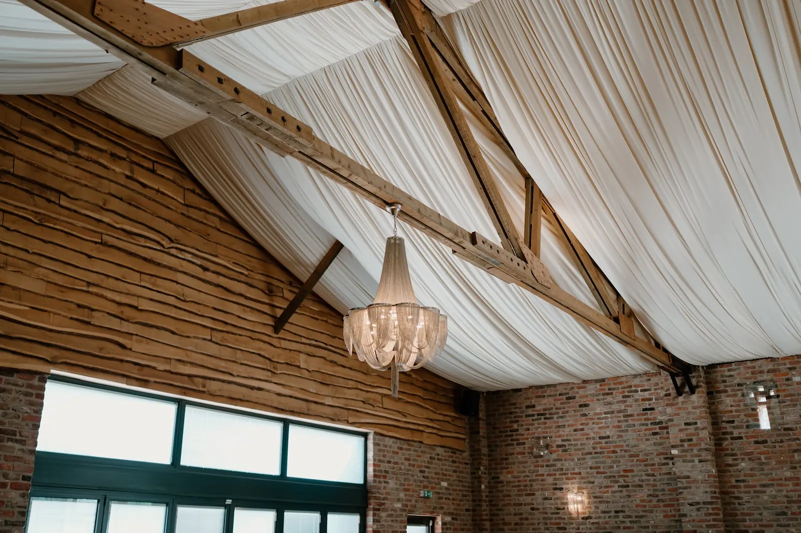 Soft ceiling drapes and a chandelier in the Old Grain Store