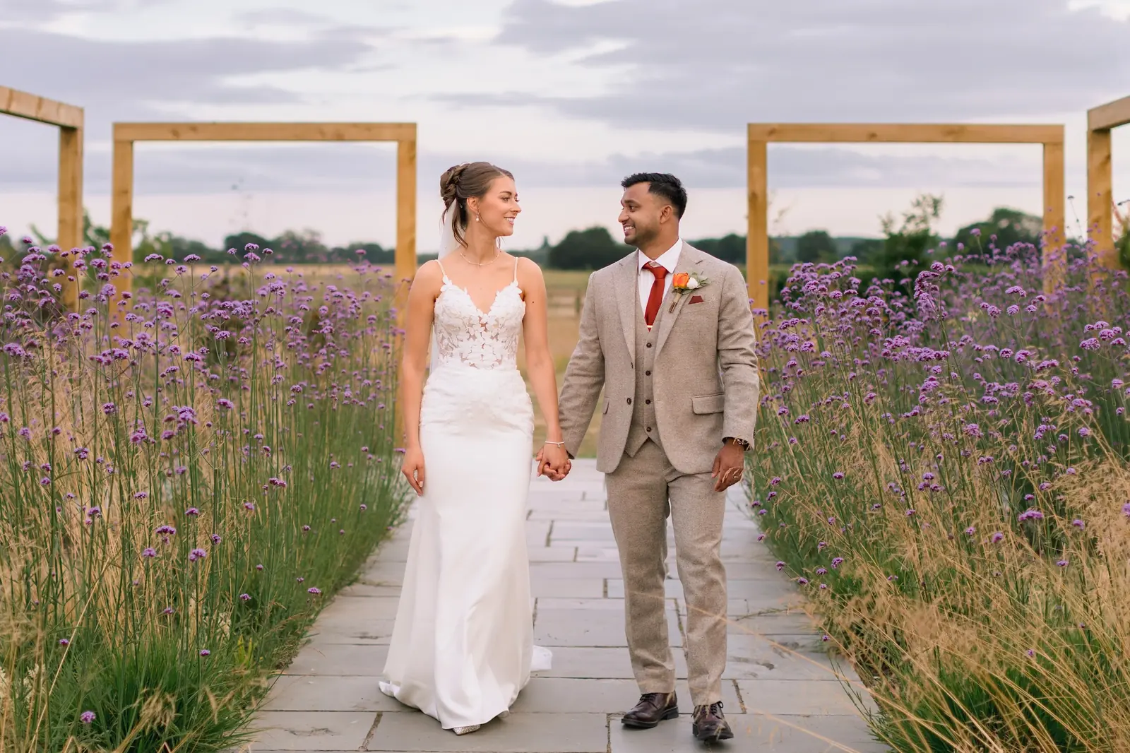 A couple walking hand in hand along the lavender walk