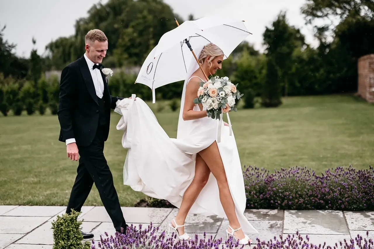A couple sharing an umbrella on the lavender walk