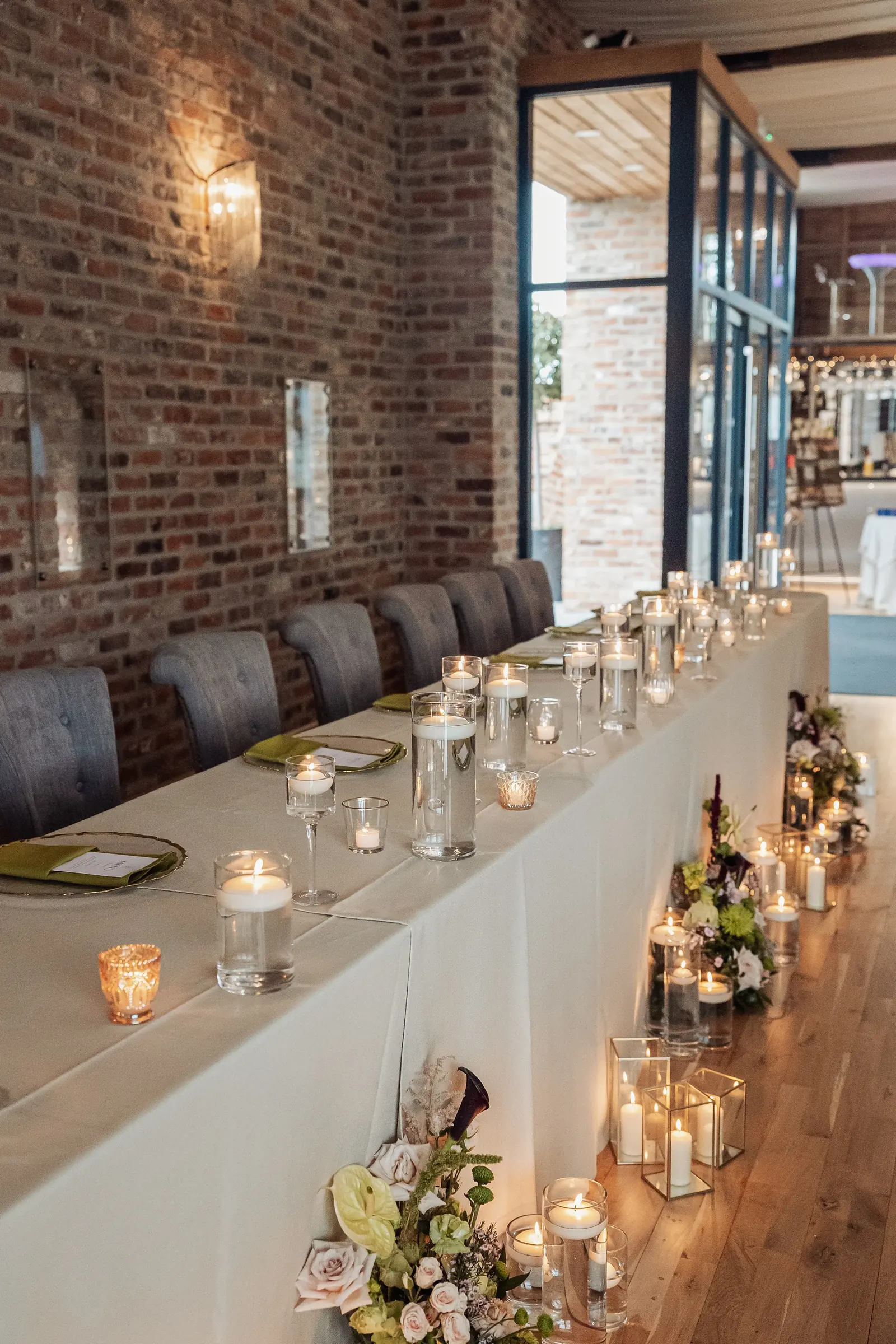 A long top table laid with candles in the Old Grain Store