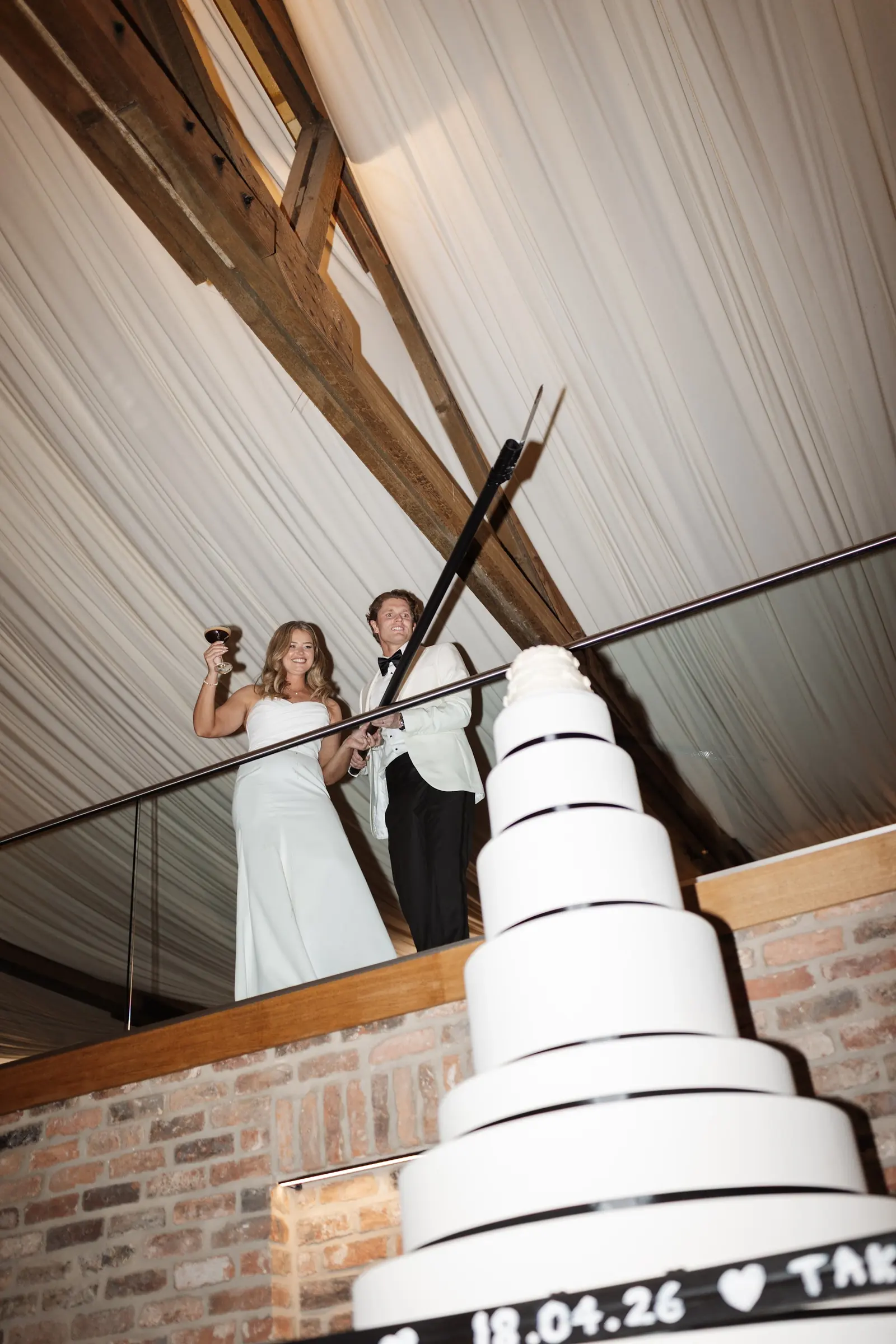 A couple on the mezzanine, looking down over the cake
