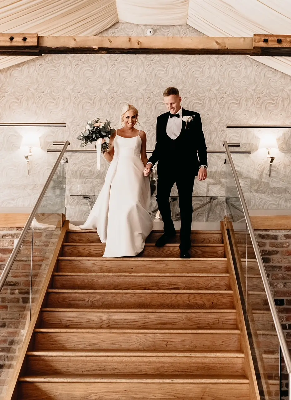 A couple walking down the staircase into the Old Grain Store
