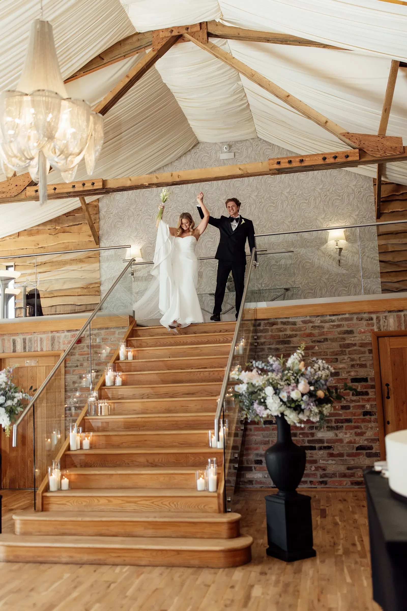 A couple at the top of the Grain Store staircase as guests look up