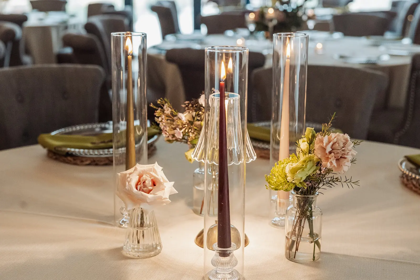 Tapered candles and roses on a dressed table